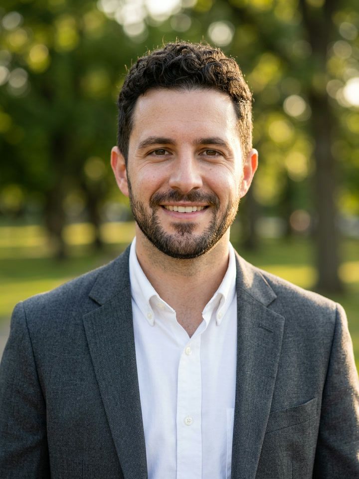 Outdoor portrait: the same man in a blazer in a sunlit park