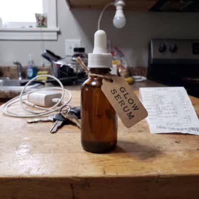 Original: a small, soft photo of a serum bottle on a kitchen counter